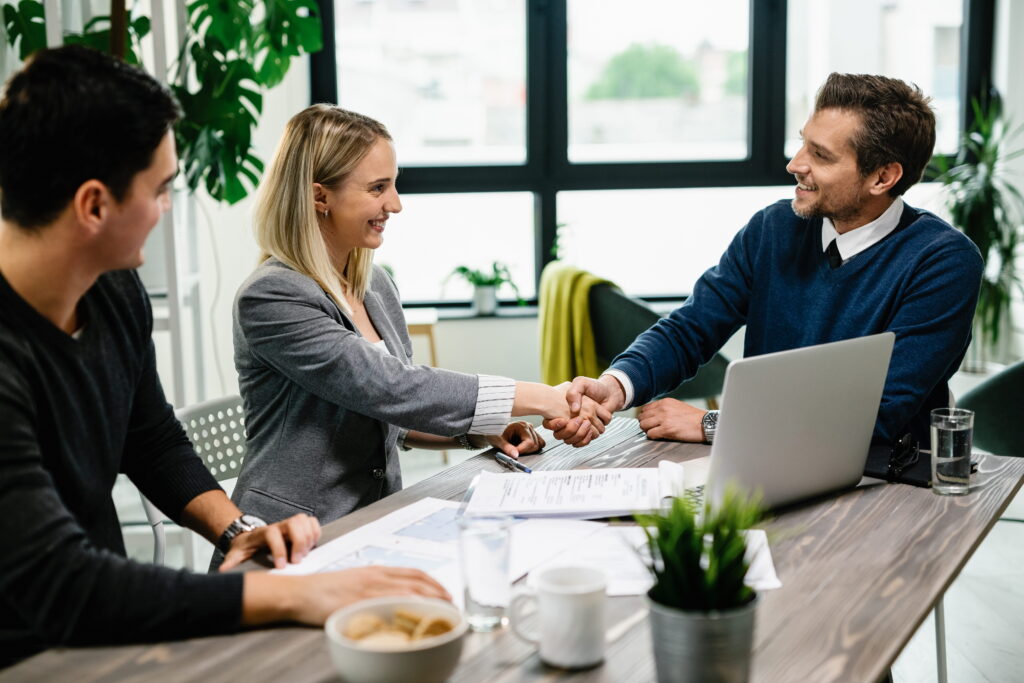 young-happy-couple-meeting-with-financial-advisor-office-woman-is-handshaking-with-agent (1)